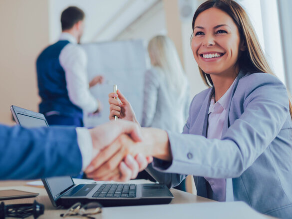 smiling women shaking hands